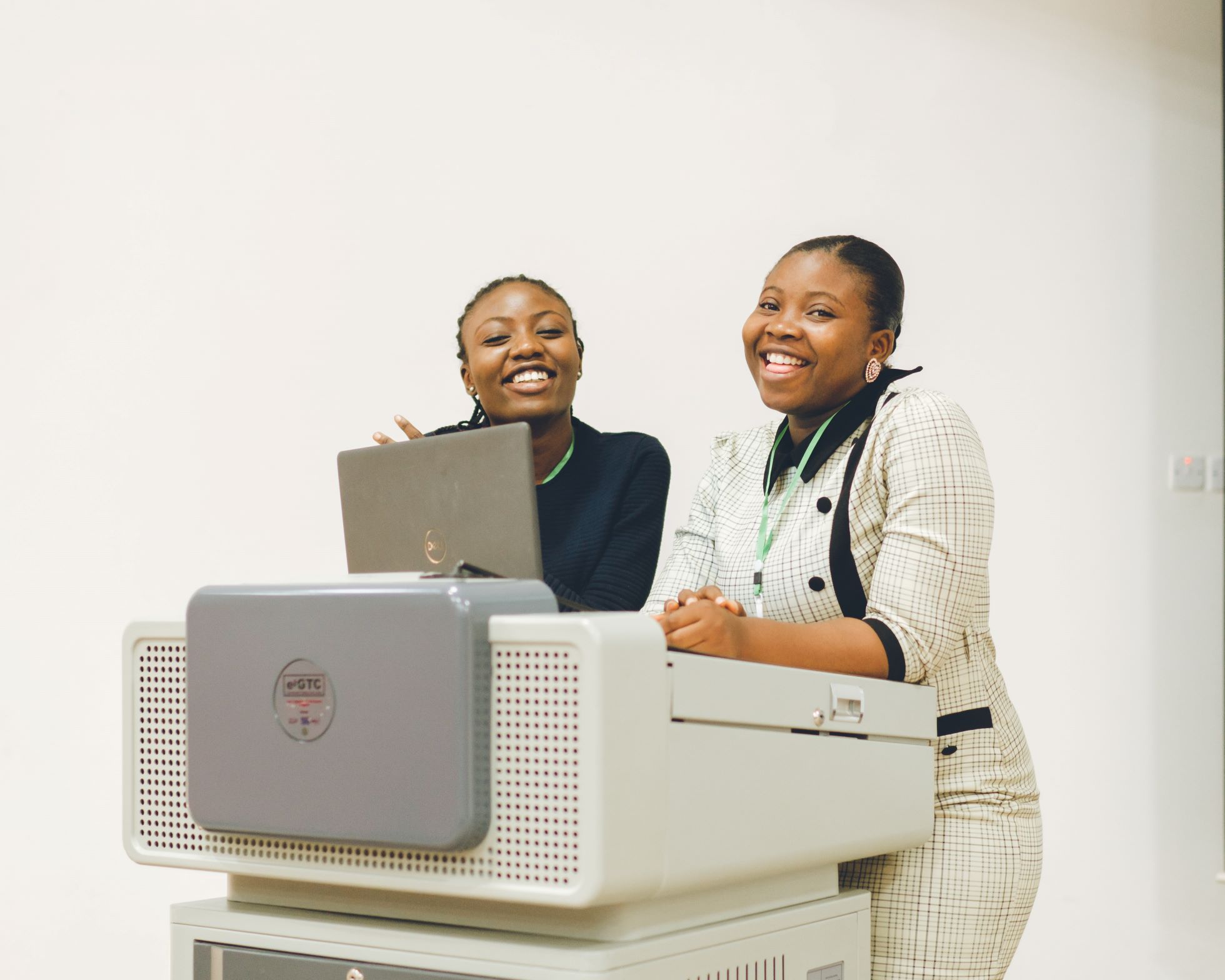 Team members reviewing a laptop on top of installed lab equipment